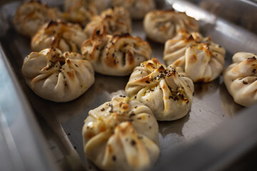 empanadas on the metal tray of a food buffet