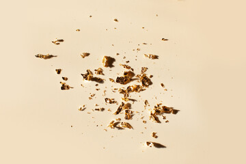 gold flakes on white background - obrazy, fototapety, plakaty