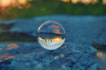 Shenandoah national park Sunset is reflected in a Crystal Ball, resting on a flat rock. 