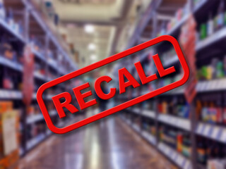 Blurry interior of a liquor store aisle behind large red Recall text