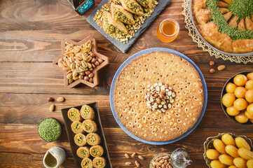 Arabic Cuisine: Middle Eastern desserts. Delicious collection of Ramadan traditional desserts. Served with tasty nuts, honey syrup and sugar syrup .Top view with close up.