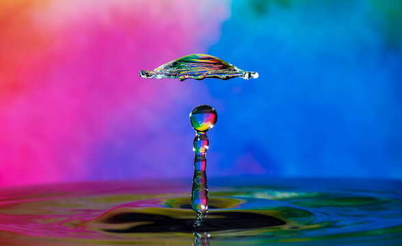 Crystal spin wheel, umbrella, mushroom, flying hat, sunflower, a person wearing a hat shapes - water droplet splash collision forms different colorful beautify abstract shapes in dreamy background