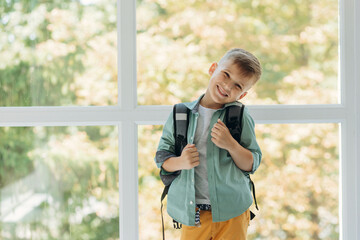 portrait of a happy smiling schoolboy with a backpack