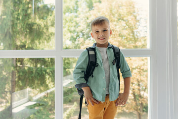 Obraz premium portrait of a happy smiling schoolboy with a backpack