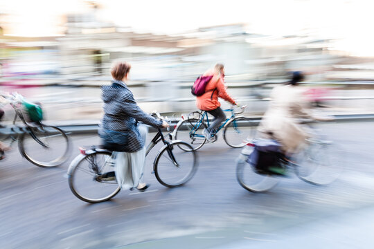people ride bicycle on a street