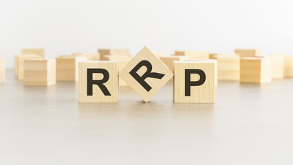 word RRP is made of wooden blocks on white background