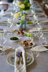 beautiful setting of a large table with snacks and flowers. 