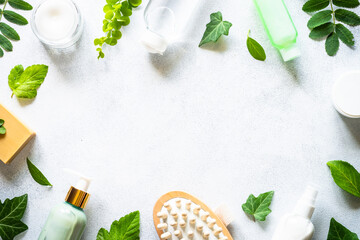 Fototapeta na wymiar Natural cosmetics concept. Skin care product, cream, serum, soap, mask with green leaves. Flat lay image on white with space for text.
