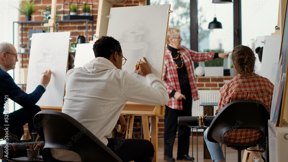 Poster african american student using pencil to draw vase sketch on canvas, attending art workshop. artisti