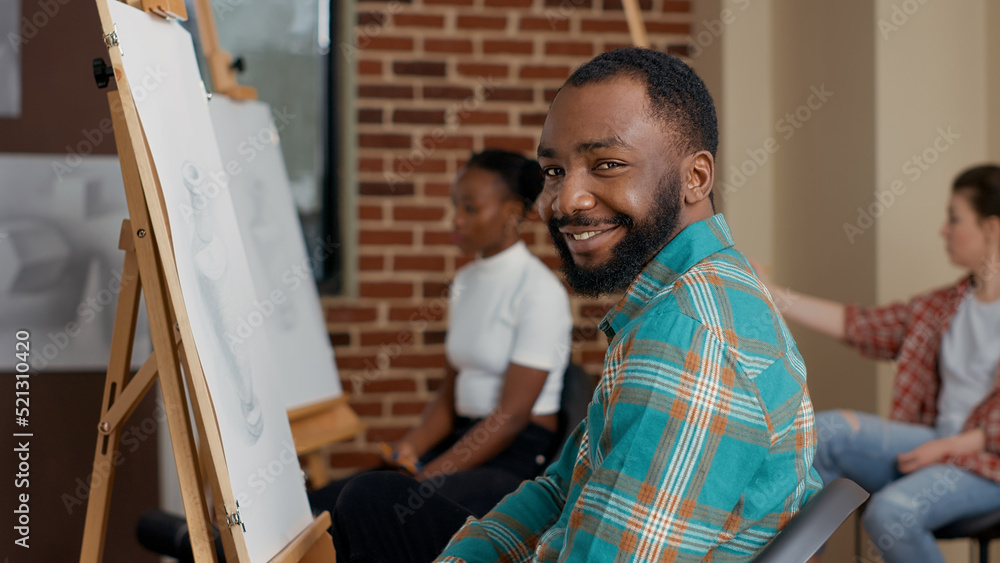 Poster portrait of young man learning to draw vase model at educational program, attending art class lesson