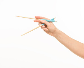 hand holding chopsticks on white background isolated