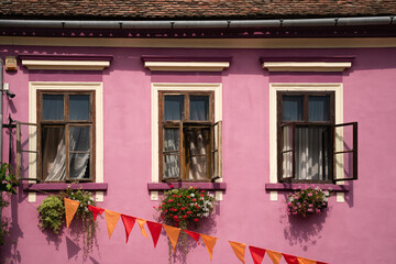 Fototapeta na wymiar Pink Building With 3 Windows, Sighisoara Romania