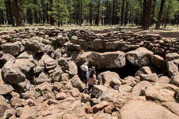 The Famous River Lava Tube in Flagstaff, Arizona where at Cave was formed by flowing Lava from and Eruption with a Family beginning their Exploration