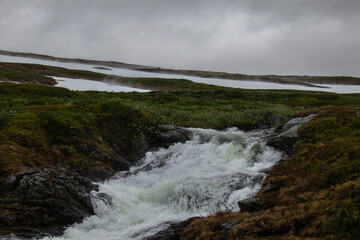 A stream of water from the melting snow along the hiking trail between Storulvans and Blahammaren Mountain Stations in Jamtland, Sweden