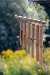 Home decoration concept, Selective focus of brow handmade bamboo wind chimes hanging on porch,...