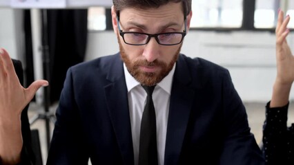 Conflict between employees. Business partners of different nationalities have a disagreement, cannot find a compromise, argue emotionally, sitting at a table in the office, shouting