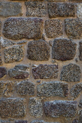 Roman defensive stone wall texture with irregular polygonal blocks built in ancient times. Vertical background with copy space