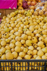 Juicy guavas placed on a shelf for sale inside a market
