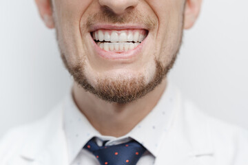 Closeup shot of male mouth with clear aligners on his teeth