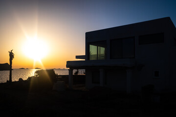 Sunset silhouette of a traditional Ibizan house