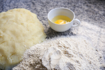 Raw Dough and Flower Ingredients on the Table. Top View of Kitchen Ingredients.