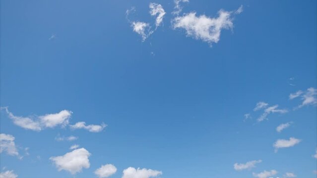 Time lapse of rolling puffy clouds are moving, white clouds time lapse. Clouds running across the blue sky. 4k Timelapse of white clouds with blue sky background.