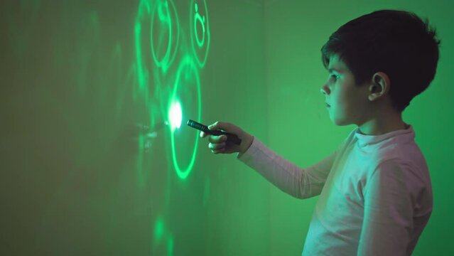 interactive games, cute male children draw with lanterns using light on the wall, physics and science