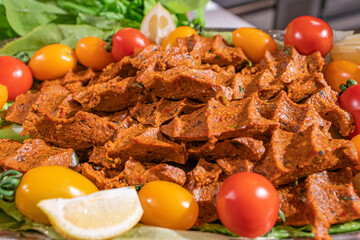 Çiğ Köfte (Raw Meatballs) is made with bulgur, ground meat, tomato paste, pepper paste,...