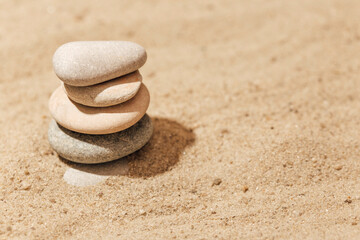 Fototapeta na wymiar stones stack on sand, zen meditation