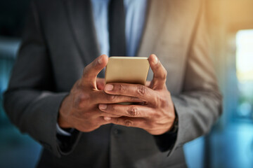 Business man browsing the internet on his phone texting and posting on social media. Closeup of a male entrepreneur browsing or searching a website or web for news or clickbait