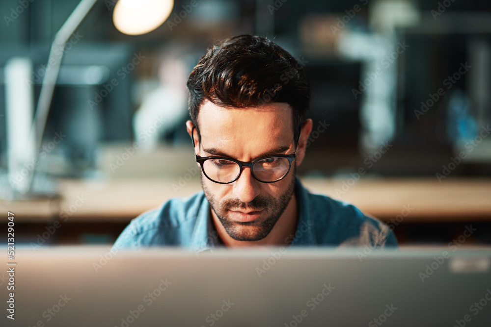 Poster serious business man working at computer late in the office at night to finish reports, articles or 