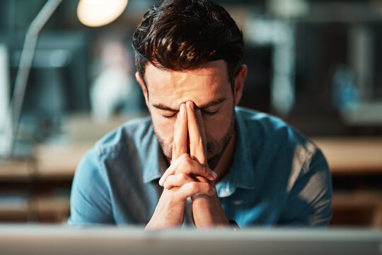 Stressed, tired and frustrated businessman with headache at night from burnout or making mistake on computer. Overworked creative entrepreneur failing to meet late office deadline or working overtime