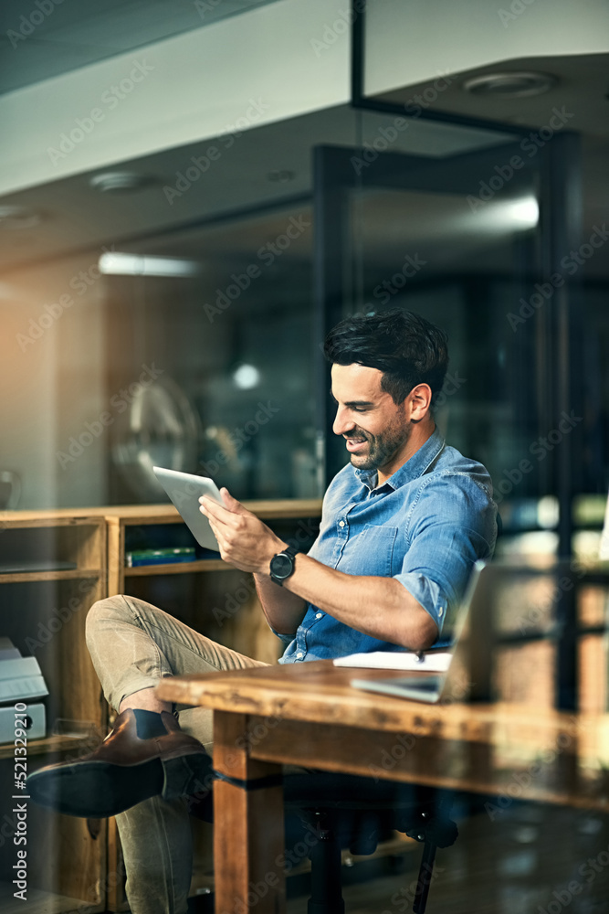 Poster business tools just keep getting smarter and smarter. shot of a young businessman using a digital ta
