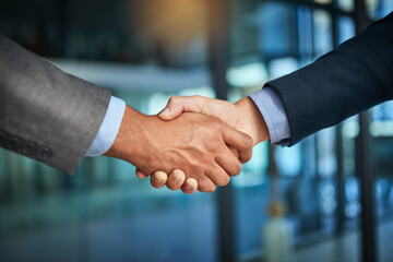 A handshake showing teamwork, collaboration and togetherness by business colleagues after a meeting...
