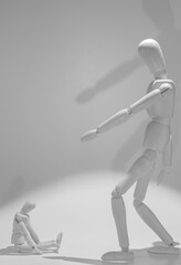 wooden mannequin scolding another smaller mannequin.