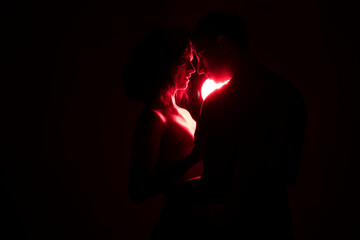 silhouette of a couple. Couple in love. Red light. Neon. Love.