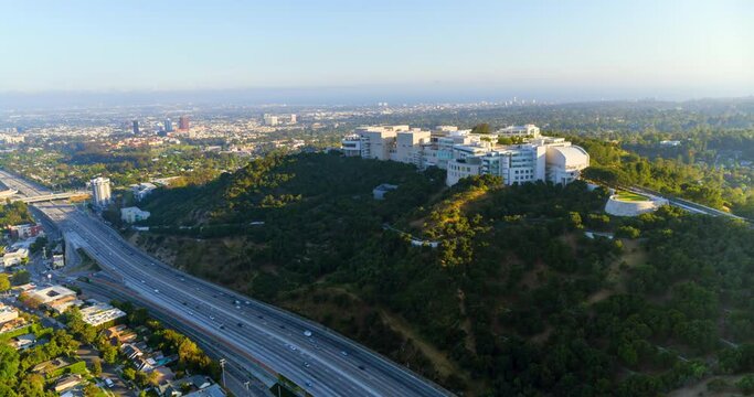 Aerial Moving Forward To The Massive Getty Research Institute Hillside Campus With A Busy Freeway In The Foreground - Los Angeles, California