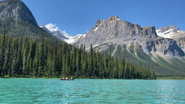 Emerald Lake in Yoho National Park as tourists use canoes on the lake