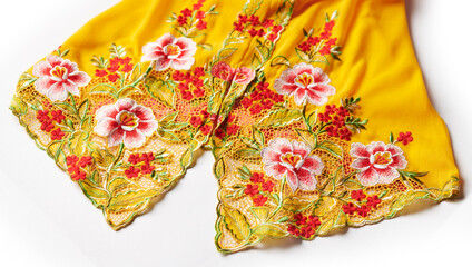 Yellow nyonya kebaya cloth with intricate embroidery of red flowers