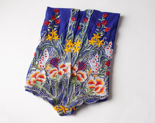 Blue kebaya cloth with intricate embroidery of orange, yellow & red flowers. Traditional nyonya cloth.