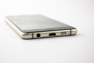 Smartphone white background. Metal smartphone isolated. Smartphone connector output.