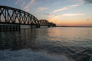 Louisiana boat near draw bridge outside new orleans at sunset