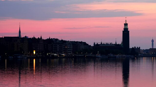 Stockholm, Sweden The City Hall or Stadshuset at dawn reflected in Riddarjarden.