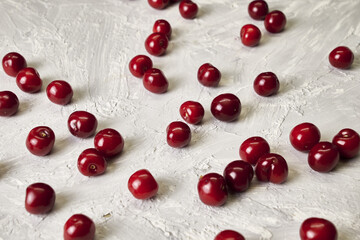 red ripe cherries scattered on the table