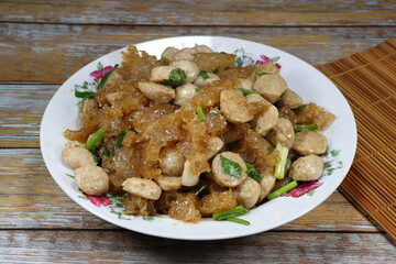 Traditional fried fresh pork skin with pork ball serving on the plate. Famous ancient menu in Chinese restaurant.