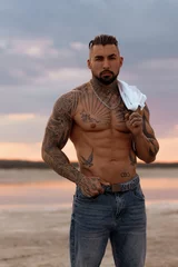 Handsome young muscular italian man posing shirtless on the beach, sunset summer time © 3kstudiok