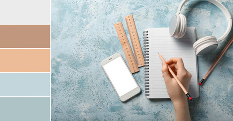 Female hand with notebook and gadgets on blue background. Different color patterns