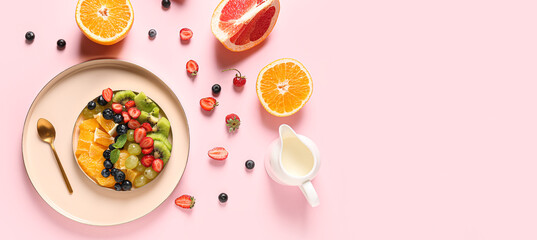 Composition with tasty fruit salad on pink background with space for text