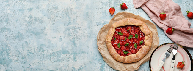 Composition with delicious strawberry galette on light blue background with space for text