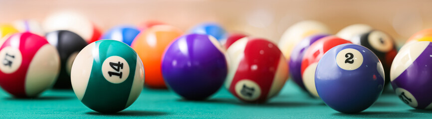 Colorful billiard balls on table, closeup